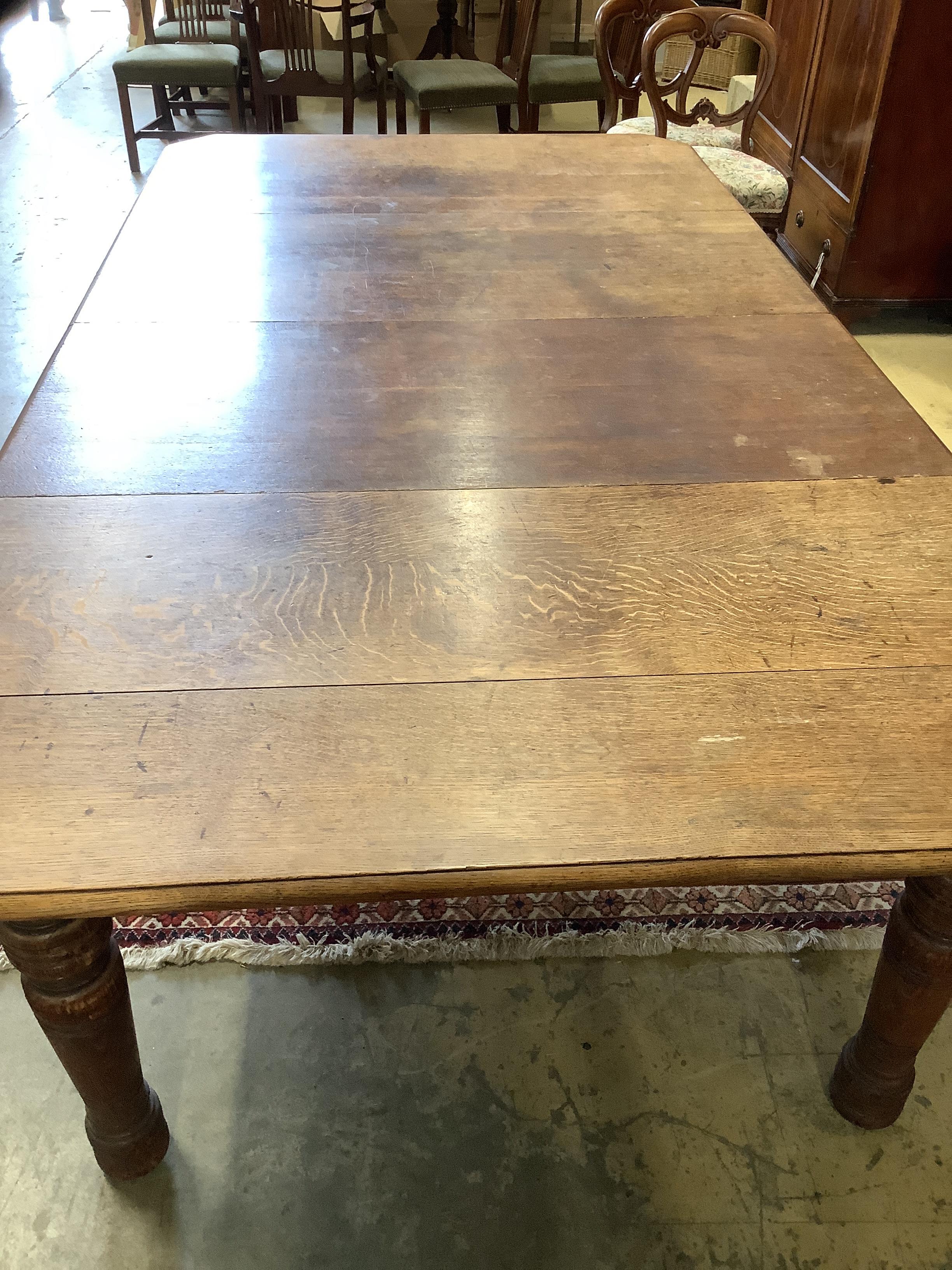 A late Victorian Aesthetic period oak extending dining table, 258cm extended, two spare leaves, width 140cm, height 73cm